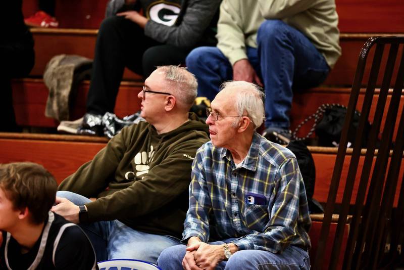 Newly named IHSFCA Hall of Fame coach Charlie Waca (right) took in Tuesday's game at Prouty Gym with his son, Chris, to watch his granddaughters, Avery and Alexander Waca, perform with the PHS poms. Charlie Waca had a 38-year Hall of Fame coaching career with stops as an assistant for his hometown Tiskilwa, Princeton and Kewanee teams.