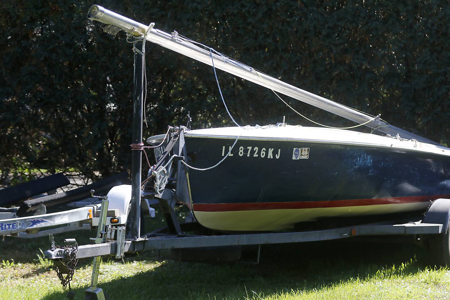 A sailboat and trailer parked at Pistakee Yacht Club on Tuesday, Oct. 3, 2023. The yacht club has been parking boats and trailers on a lot next to the club since 1970, with a variance from the county. The Village of Johnsburg says they are in violation and have to move them boats and trailers from the lot.