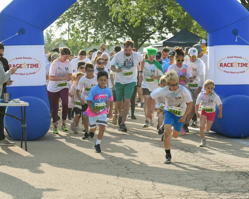 Runners take off at the start line on Saturday, June 7, 2025, during the CASA DeKalb County 5K Color Run held at the Sycamore Middle School.