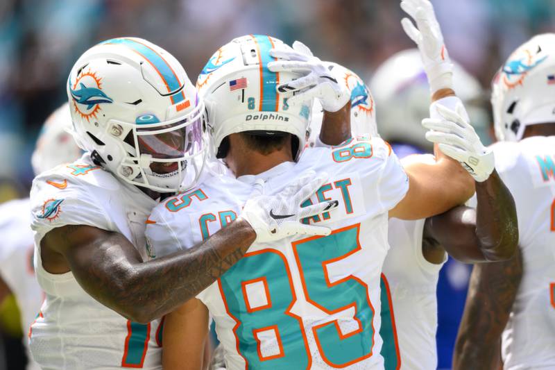 Miami Dolphins wide receiver River Cracraft (85) celebrates scoring a touchdown with Miami Dolphins wide receiver Trent Sherfield (14) during an NFL football game against the Buffalo Bills, Sunday, Sept. 25, 2022, in Miami Gardens, Fla. (AP Photo/Doug Murray)