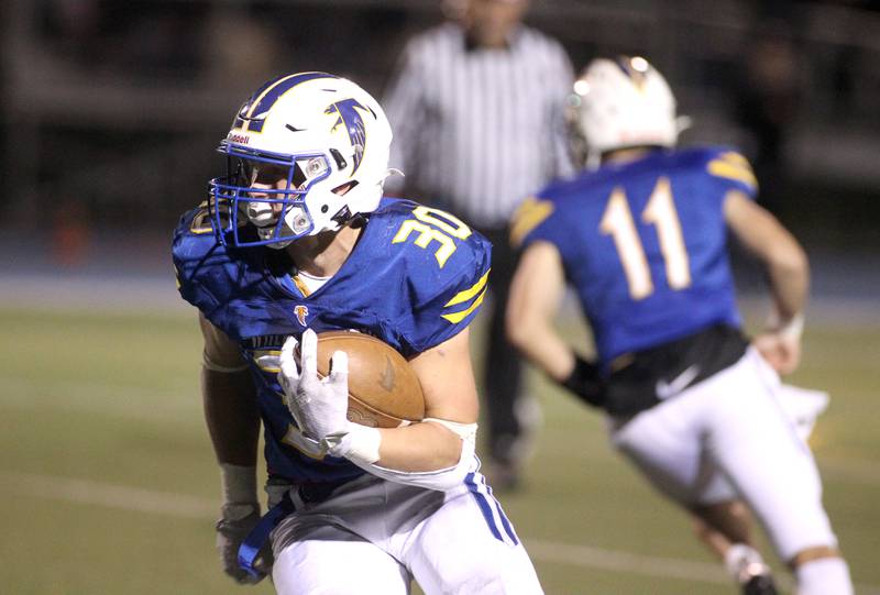 Wheaton Warrenville South’s Matthew Crider (34) runs the ball during a game at Wheaton North on Friday, Oct. 7, 2022.