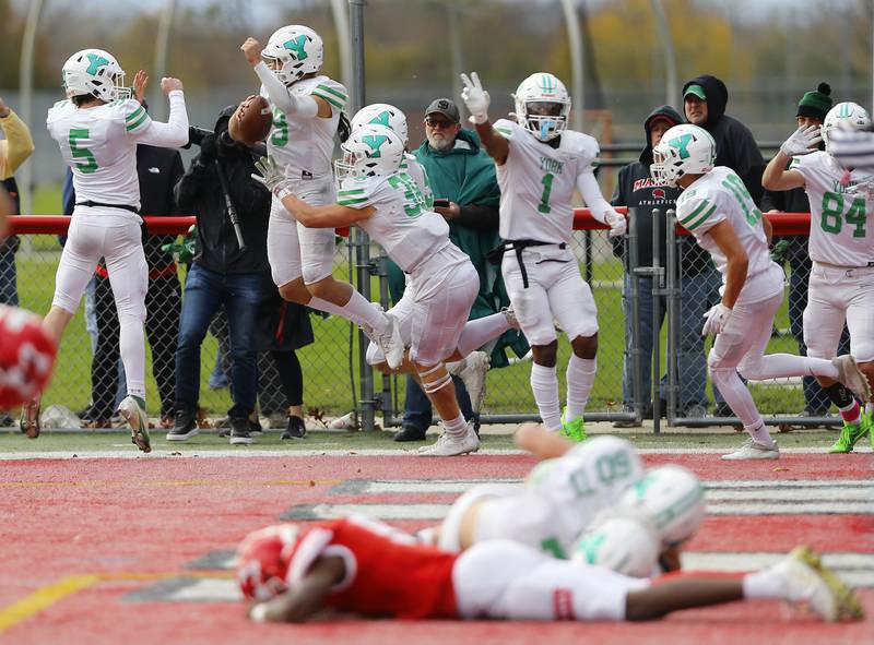 Matt Vezza (9) and the rest of the York team celebrate the winning score during a second round Class 8A varsity football playoff game between York High School and Marist High School on Saturday, Nov. 5, 2022 in Chicago, IL.