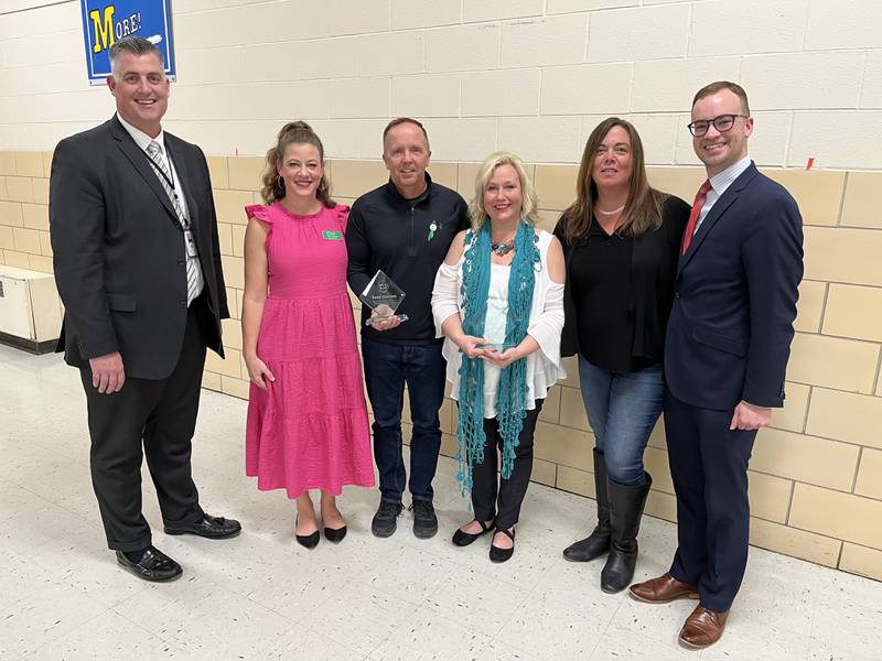 The two award winners, Cheryl Lyons and Todd Cherney, are recognized by the District 58 superintendent and members of the Education Foundation.