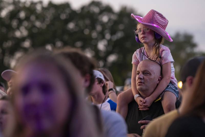 Ryleigh Steele sits atop her uncles shoulders to get a better vantage point for the Drew Baldridge concert at Streatorfest on August 2, 2024.