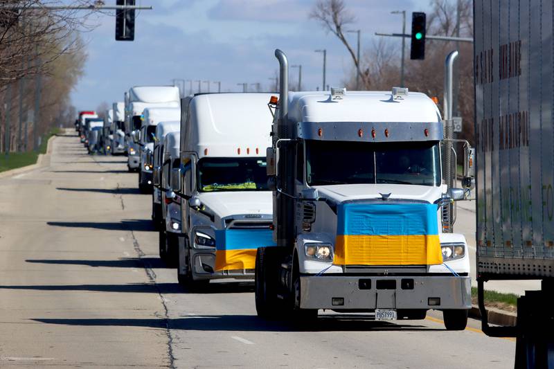 Drivers travel on Beverly Road in Hoffman Estates Saturday morning as they begin the Deblockade Mariupol truck protest rally hosted by Help Ukraine Foundation LTD to bring attention to the blockade of Mariupol.