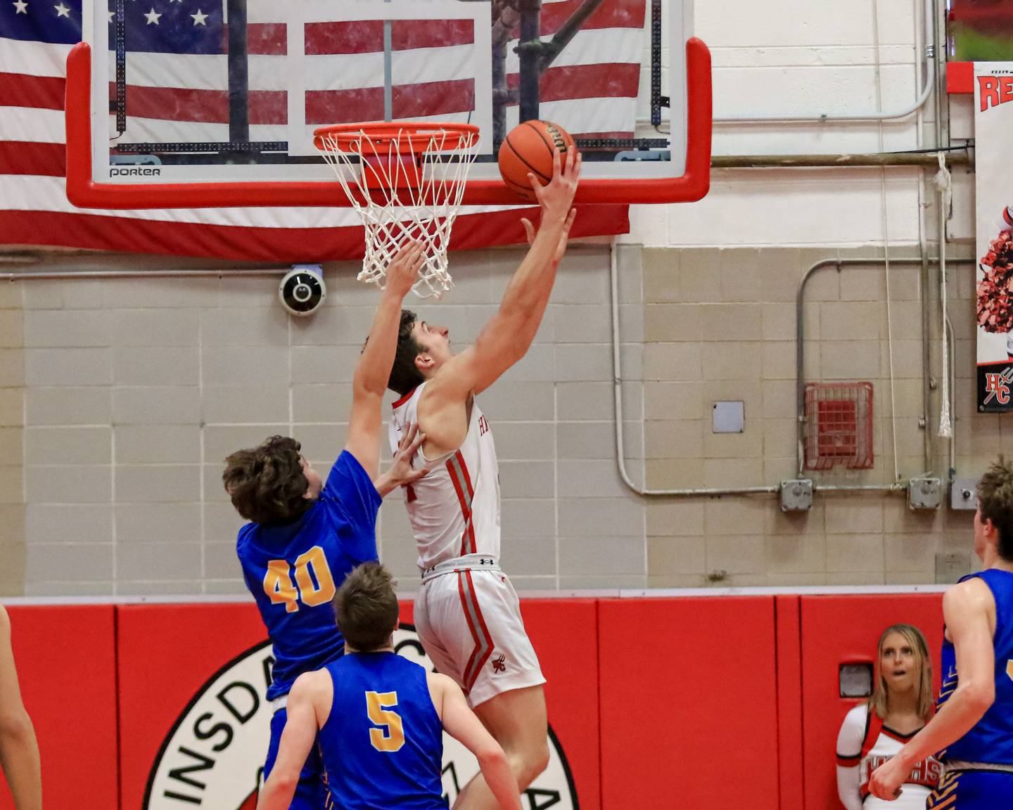 Hinsdale Central's Chase Collignon (4) puts up a reverse layup over Lyons Brady Chambers (40) during varsity basketball game between Lyons at Hinsdale Central.  Jan 20, 2023.