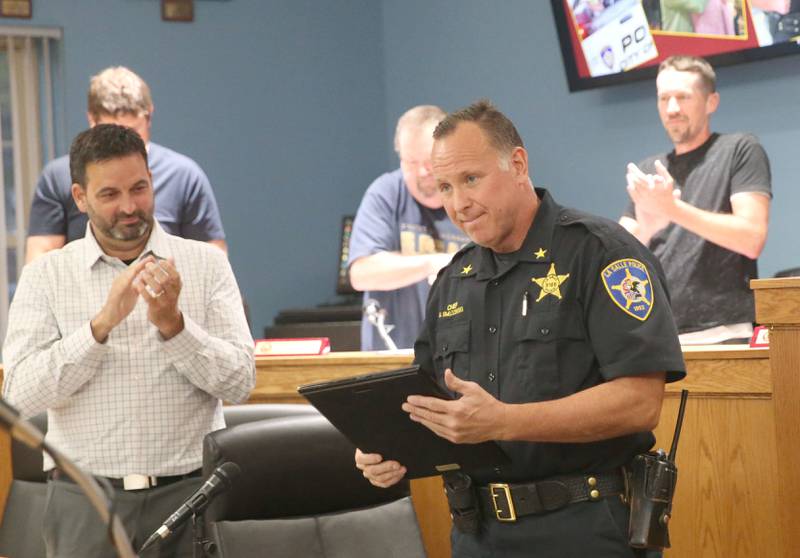 La Salle Police Chief Mike Smudzinski holds a service plaque during the La Salle City Council meeting on Monday, Sept. 29, 2025. Smudzinski has been with the La Salle Police Department for 28 years and became Police Chief in 2020. Smudzinski officially retires on Oct. 10, 2025.