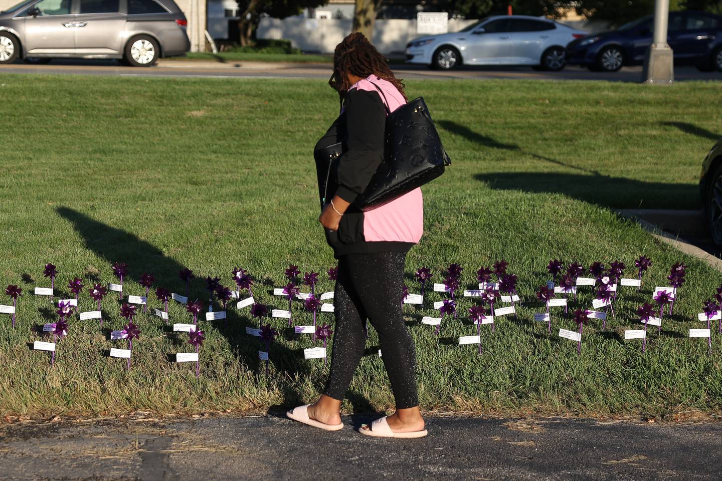 Leah Hudson looks over the names of children lost to domestic violence at the Take Back the Night event at Hufford Junior High on Thursday, Oct. 5, 2023 in Joliet.