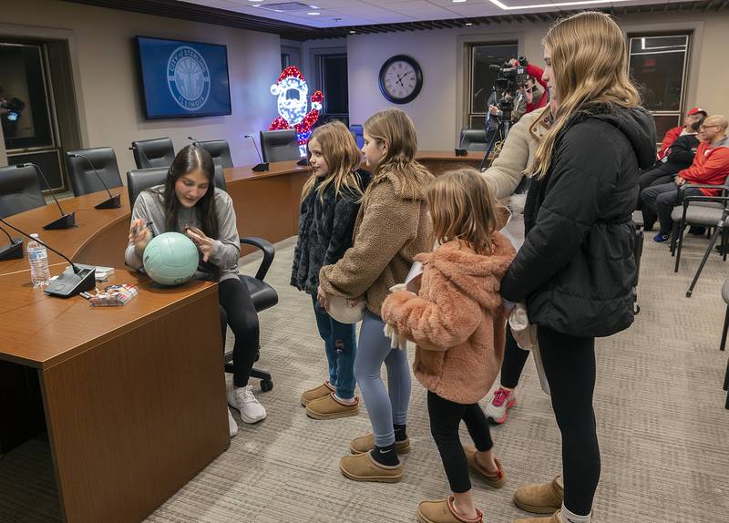 Members of the Kelly family, Jamaeson (left), 9, Hayden, 11, Geneva, 7, and Gillian, 14, grab autographs from volleyball star Lexi Rodriguez Monday, Dec. 23, 2024, in Sterling.