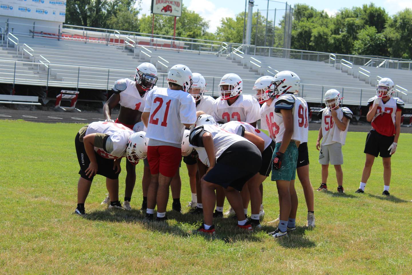 Quarterback Jerrad Clark (21) leads the huddle Wednesday, July 16, 2025, during Streator High football practice at Doug Dieken Stadium in Streator.
