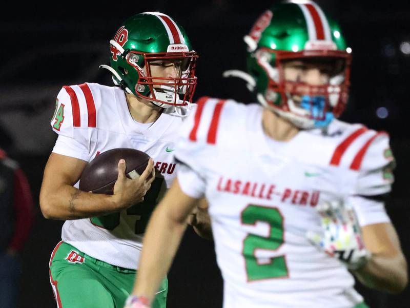 La Salle-Peru’s Easton Moriarty follows the blocking of Landon Zellers during their game Friday, Oct. 10, 2025, at Sycamore High School.