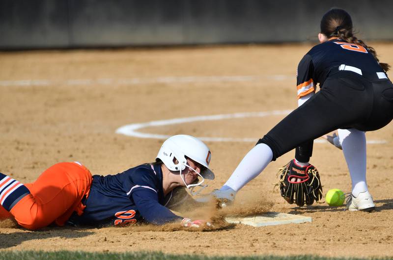 Oswego’s Savannah Page steal second base as Wheaton Warrenville South’s Becca Chaney takes the low throw during a game on April 10, 2025 at Wheaton Warrenville South High School in Wheaton.