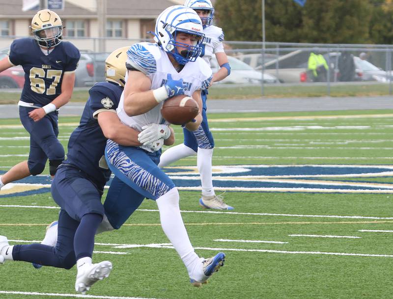 Princeton's Casey Etheridge makes a catch as Central Catholic's Connor Rave makes the stop durring the Class 3A playoffs on Saturday, Nov. 1, 2025 at Central Catholic High School in Bloomington.