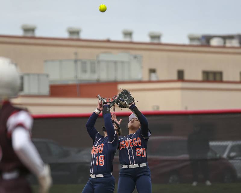 Oswego's Jaelynn Anthony (20) and Oswego's Leah McKenzie (18) converge on a popup to second during softball game between Oswego at Yorkville. May 5, 2026 in Yorkville.