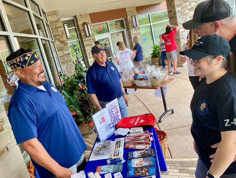 DeKalb American Legion Post No. 66 Cmdr Manuel Olalde (left), and Legion member and U.S. Army veteran Jim Hupke (middle) speaks to fellow veteran participants during the inaugural Be the One Walk, a 2.2-mile trek meant to spread awareness about veteran suicide rates. The event was held at Northwestern Medicine Health and Wellness Center in DeKalb on Sunday, Sept. 22, 2024.