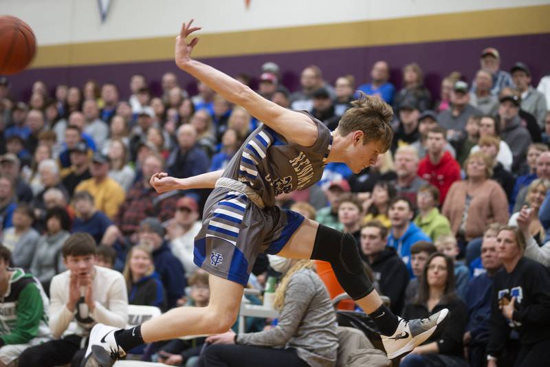 Newman's Lucas Simpson saves a ball from going out of bounds against Scales Mound in the sectional final Friday, March 4, 2022.