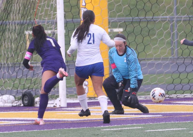 Princeton keeper Maddie Oertel misses a kick from Mendota's Crystal Garcia as teammate Yocelynn Robledo (21) helps out during the Class 1A Regional final game on Tuesday, May 20, 2025 at Mendota High School.