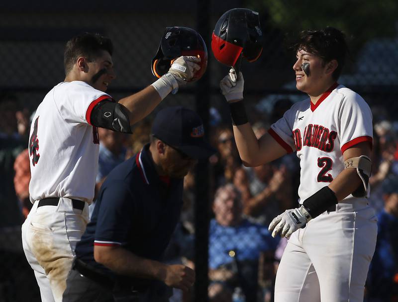 Huntley’s Brandon Hanley, right, celebrates with Ryan Quinlan after hitting a home run during a IHSA Class 4A baseball sectional semi-final baseball game between Jacobs and Huntley at Jacobs High School in Algonquin.