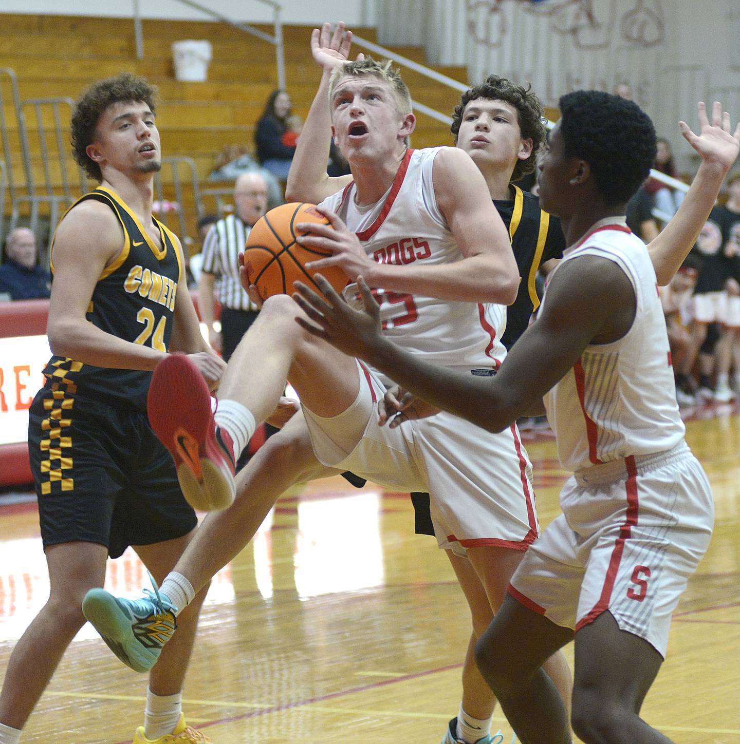 Streator’s Joe Hoekstra (25) gathers an offensive rebound in front of Reed-Custer's Colton Waldvogel (24) and prepares to go back up with a putback in a game earlier this season at Streator's Pops Dale Gymnasium.