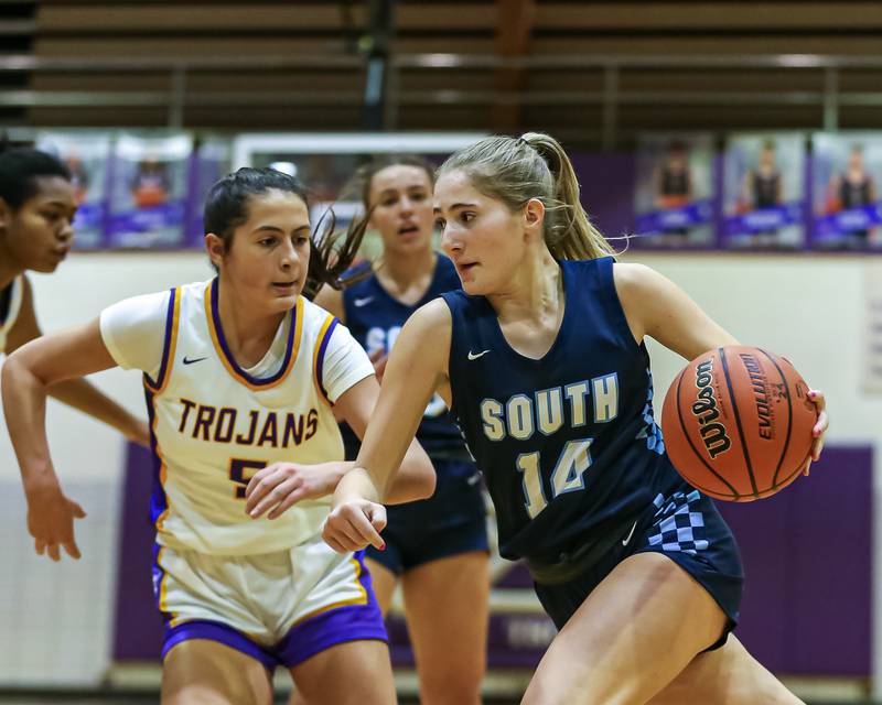 Downers Grove South's Allison Jarvis (14) drives past the defense during girls basketball game between Downers Grove South at Downers Grove North. Dec 16, 2023.