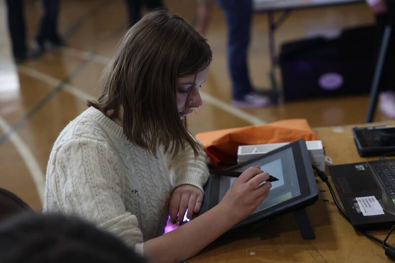 A student works on a table at the graphic design table at the Grundy Area Vocational Center 8th grade Career Fair at Morris High School on Tuesday, Oct. 29, 2024 in Morris