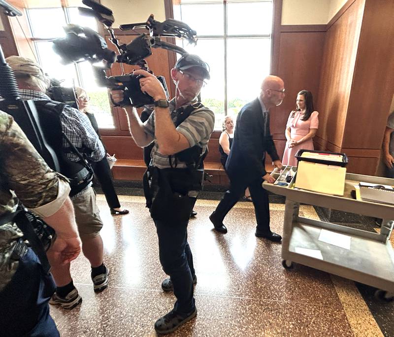 Ogle County State's Attorney Mike Rock walks past a 48 Hours film crew after a sentencing hearing for Matthew Plote on June 27, 2024 at the Ogle County Judicial Center in Oregon. Plote, 37, of Malta, was sentenced to life in prison for the 2020 murder of Melissa Lamesch, 27, of Mt. Morris, and her unborn baby boy.