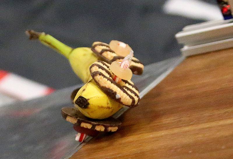 A edible banana car built by Trinity Catholic Academy students turnes sideways at the bottom of the ramp during the 18th annual Editable Car Contest on Wednesday, Feb. 28, 2024 at Illinois Valley Community College in Oglesby.