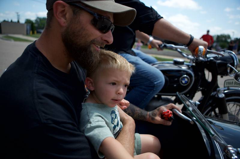 Sycamore boy Oilver Olinger, 2, and Dad Nathan Olinger sit in a sidecar outside Sycamore Public Library on Sunday, June 22, 2025.