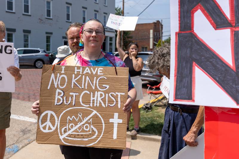 Protester holds sign at the “No Kings” protest on Saturday, June 14, 2025 at Rotary Park in Princeton.
