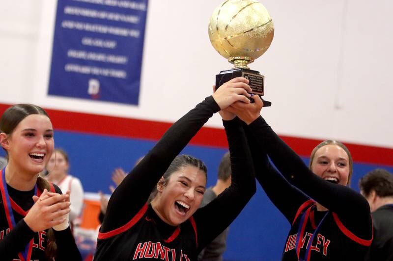 Huntley’s Red Raiders celebrate a win over Maine South in Komaromy Holiday Classic varsity girls basketball championship game action on Monday, Dec. 30, 2024, at Dundee-Crown High School in Carpentersville.