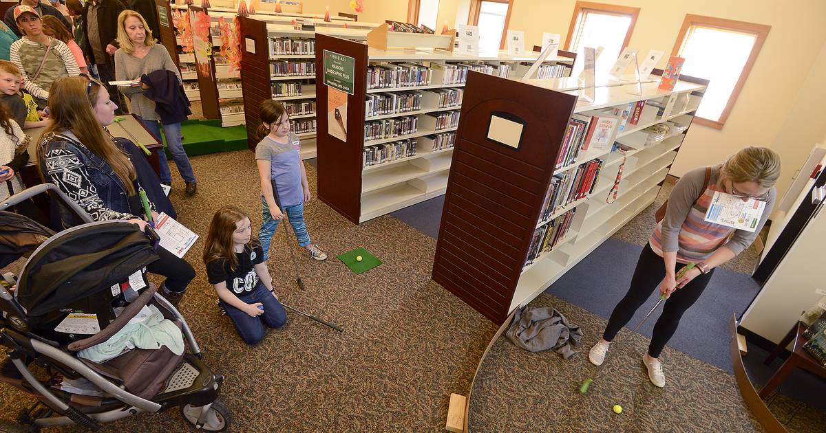 Mini golfers of all ages enjoy the game indoors at Yorkville Library’s annual FunRaiser event