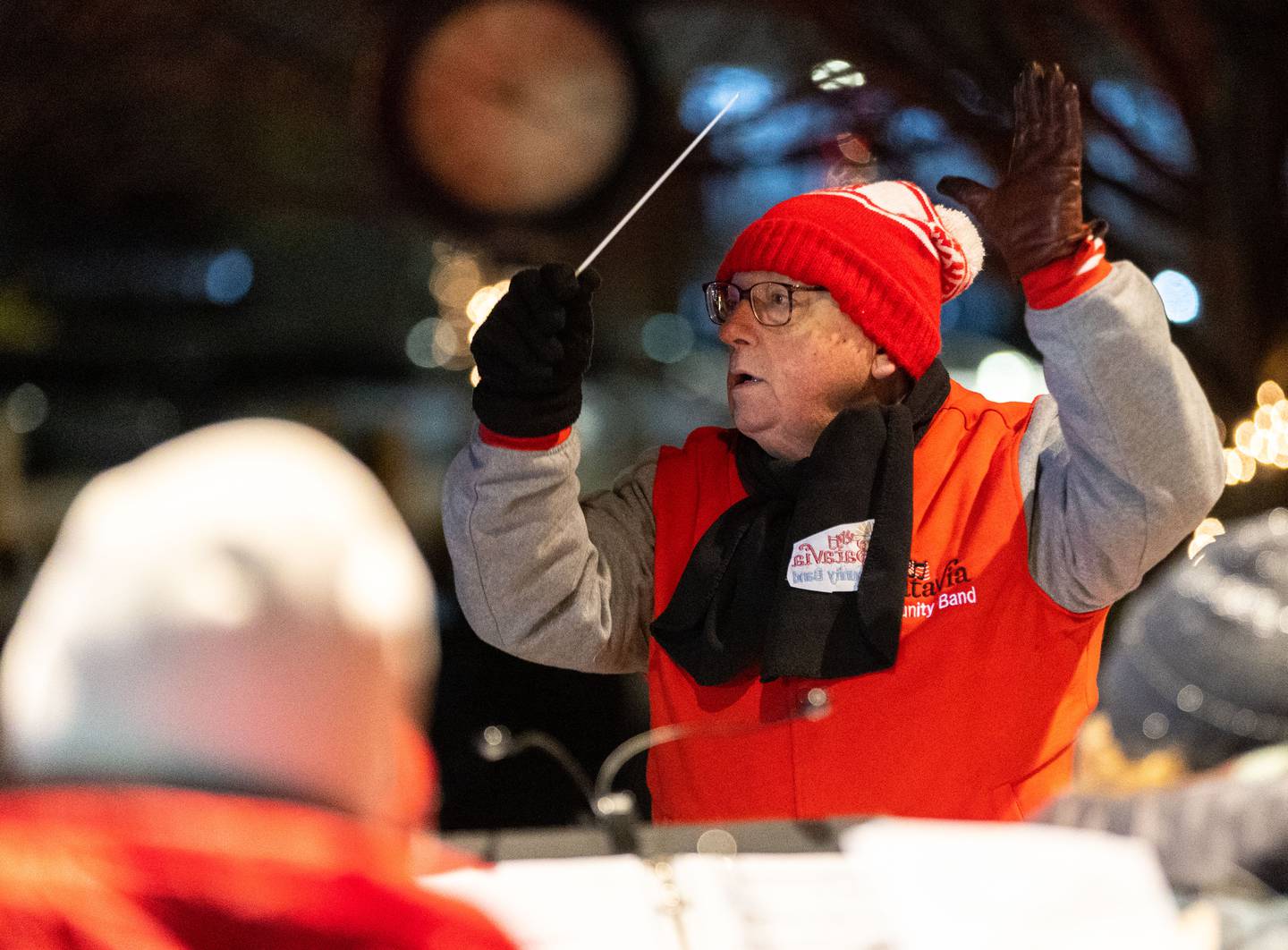 Batavia Community Band Director John Heath conducts the band through Christmas carols during the Celebration of Lights at the Batavia Riverwalk on Sunday, Dec. 1, 2024.