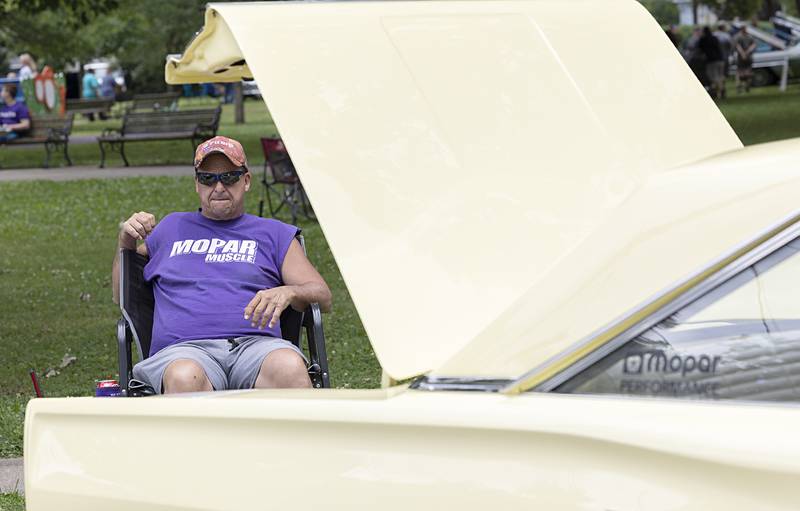 Joe Ludwig of Rock Falls sits with his 1966 Dodge Coronet Friday, July 5, 2024 for the Petunia Fest car show. The show, held at John Dixon Park, featured a few dozen hot rods, muscle cars, trucks and modern speedsters.
