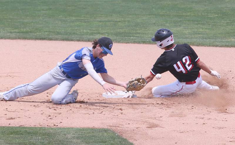 Henry-Senachwine's Carson Rowe steals second base as Newman's Garrett Matznick misses the throw to the bag during the Class 1A State semifinal game on Friday, June 2, 2023 at Dozer Park in Peoria.