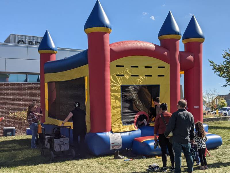 Families enjoy playing in a bouncy house during a joint safety campus open house between the Oswego Fire Protection District and the Oswego Police Department on Oct. 11, 2025.