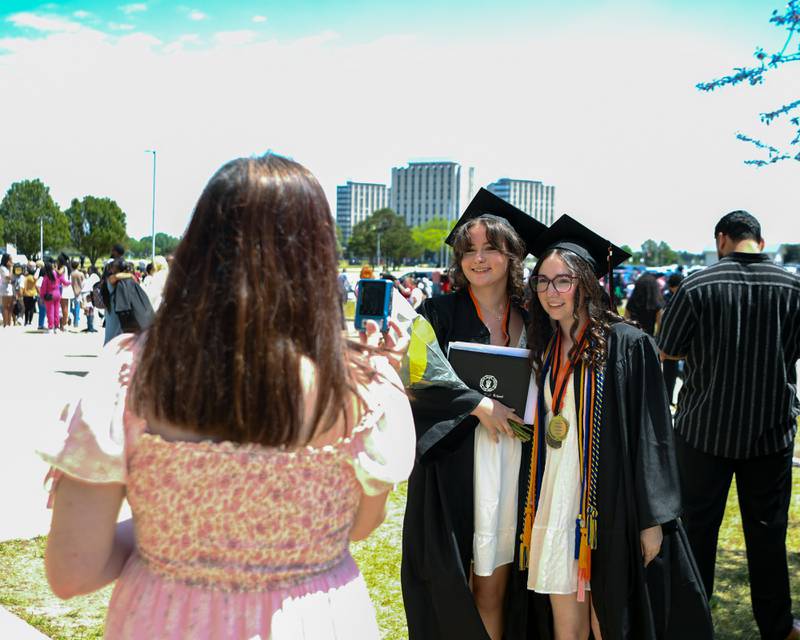 DeKalb High School graduates Kylie Kuba (left) and Mia Lundin pose for a photo after the graduation ceremony on Saturday, May 23, 2026, held outside the Convocation Center in DeKalb.