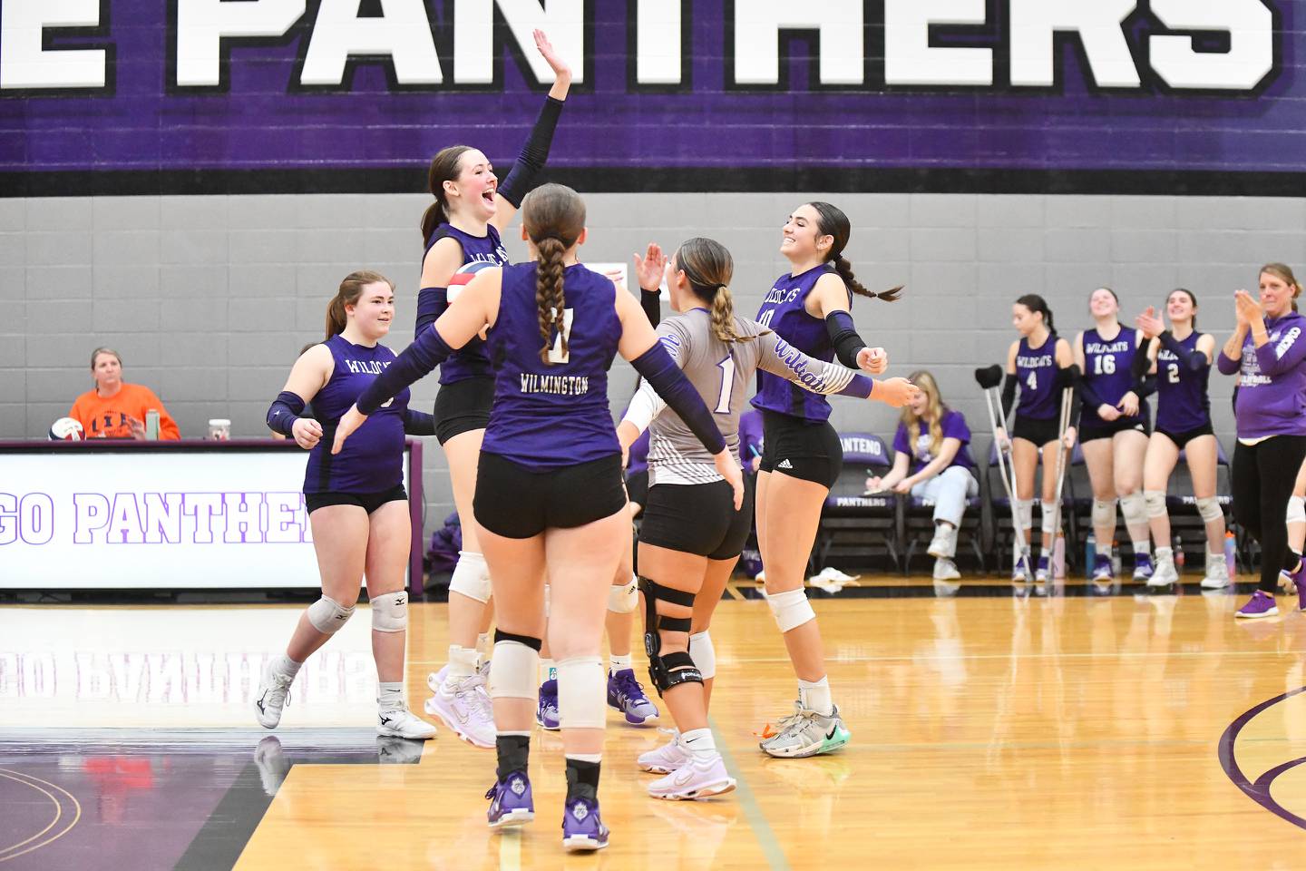 Wilmington's Maggie Lindsey leaps in the air as the Wildcats celebrate their victory in two sets over Chicago University in the IHSA Class 2A Manteno Sectional semifinal.