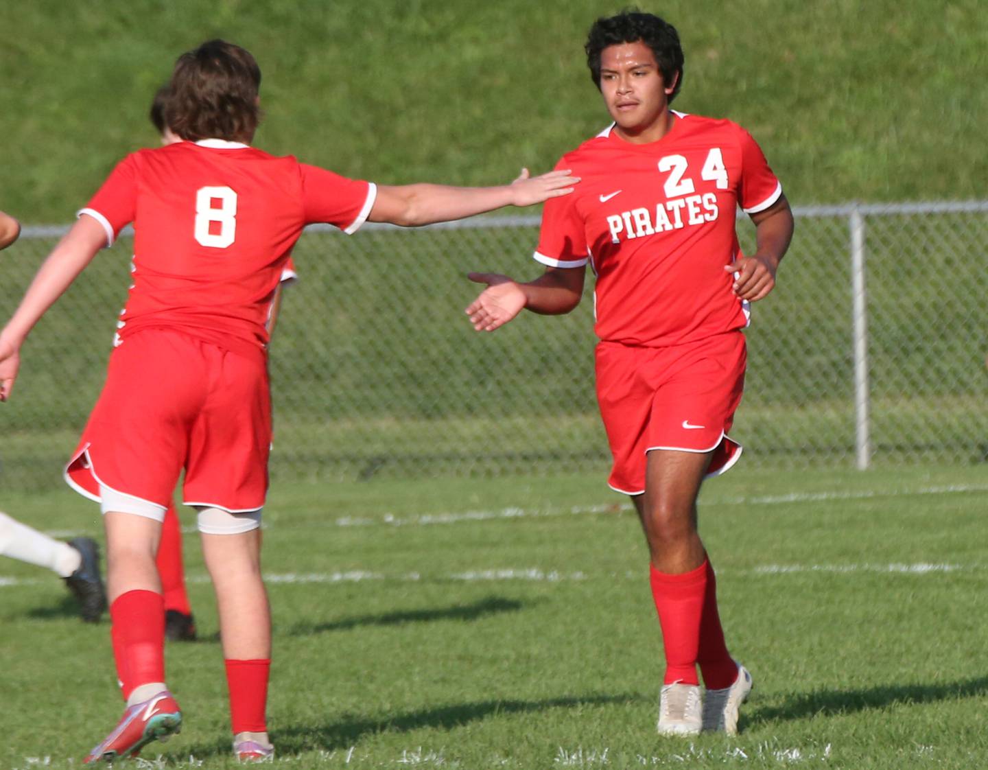 Ottawa's Luis Bedolla hi-fives teammate Mason Jaegle after scoring the teams first goal against Princeton on Tuesday, Oct. 3, 2023 at Ottawa High School.