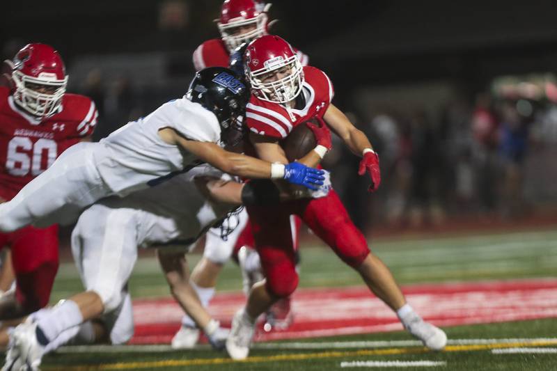 Naperville Central running back Tyler Dodd is brought down after rushing for a first down on Friday, Sept. 3, 2021, at Naperville Central High School in Naperville, Ill.