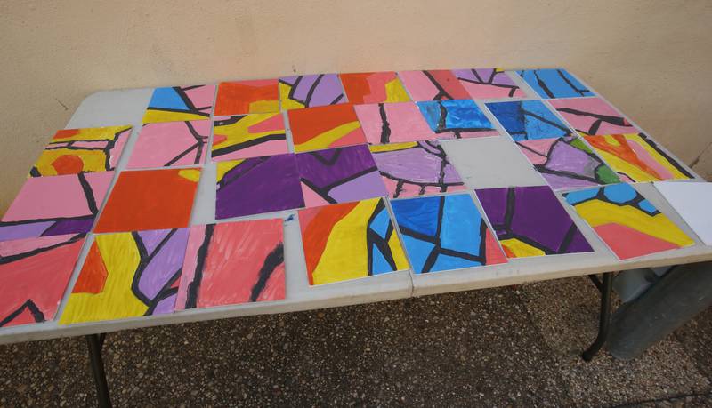 Tiles depicting of a torch was constructed through the paint a tile for the community mural project with the Princeton Public Arts Commission on Friday, June 20, 2025 downtown Princeton. The new mural will be displayed in the "Prairie Dreams" alleyway next to Fawcetts Pharmacy on South Main Street in Princeton.  “Prairie Dreams” is a living room grouping of mosaic-clad furniture (sofa, table and chairs) set under cloth sails and string lights along The Mary Uthoff Memorial Walkway.
