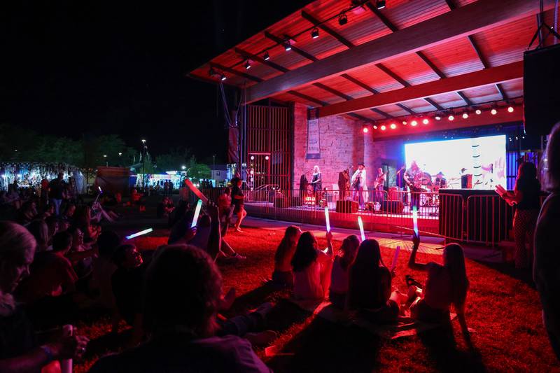 Attendees wave glow sticks as Fleetwood Gold performs during the 50th Bourbonnais Friendship Festival on Friday, June 27, 2025.