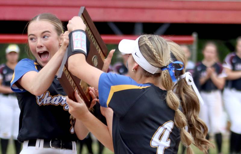 Corina Maratea, left, and Aurora Central Catholic’s Chargers celebrate a 4-3 win over Marengo in varsity girls softball IHSA Class 2A Regional Title Game action on Friday, May 22, 2026 at Raymond Benoy Field on the campus of Marian Central High School in Woodstock.