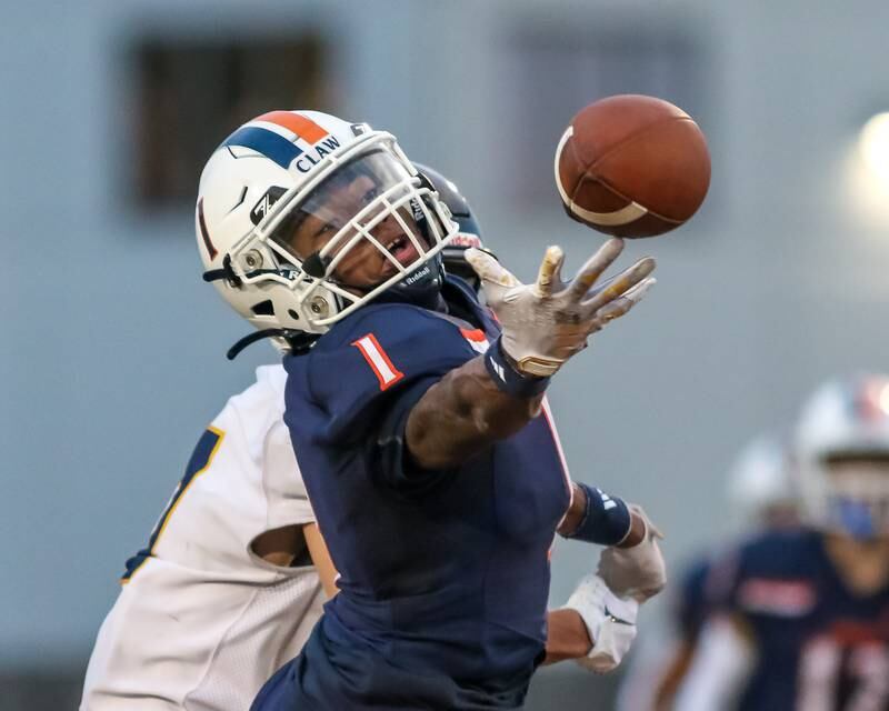 Oswego's Jeremiah Cain (1) breaks up a pass during a football game between Neuqua Valley and Oswego on Friday, Aug. 30, 2024 in Oswego. Gary E Duncan Sr for Shaw Local News Network.