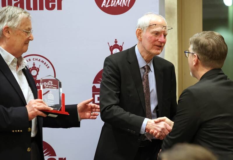 Jay Ebbesen accepts the Hall of Fame Pioneer Award from former DeKalb Mayor Jerry Smith (left) and DeKalb Chamber Executive Director Matt Duffy (right) on behalf of his father Joseph Ebbesen Thursday, Feb. 8, 2024, during the DeKalb Chamber of Commerce’s Annual Celebration Dinner in the Barsema Alumni and Visitors Center at Northern Illinois University.