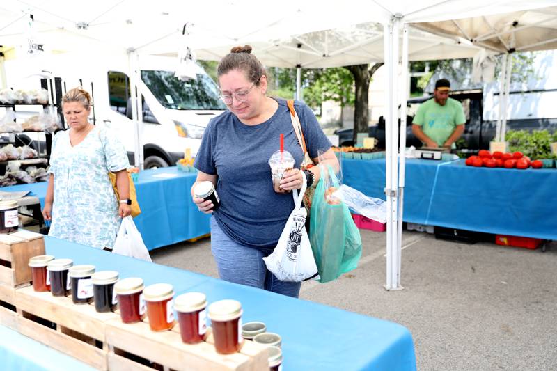 Ann Duncan-Hlavach shops at the Elmhurst Farmer’s Market on Wednesday, July 7, 2025 at the market’s new location parking lot of Elmhurst Christian Reformed Church.