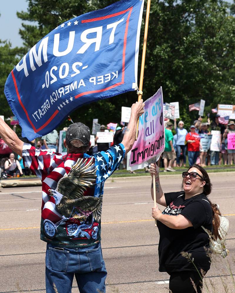 A protester (right) has a few words for Steve Bellows, from DeKalb, who is a supporter of President Donald Trump Saturday, June 14, 2025, during a No Kings rally along Sycamore Road at Hopkins Park in DeKalb. The group was protesting the policies of President Donald Trump and his administration.