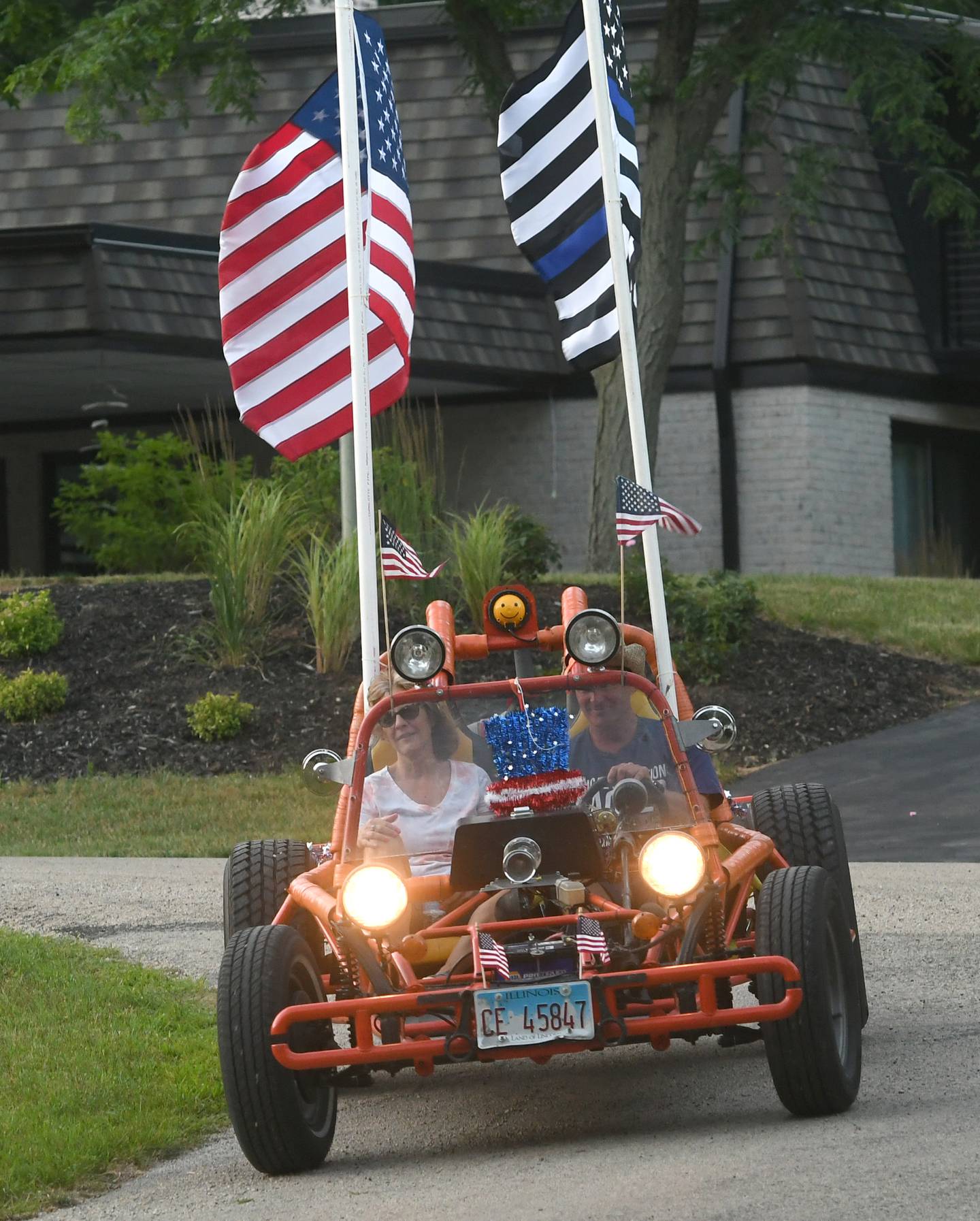Mark and Deb Gale round a curve in Grand Detour in their sand buggy during the 2022 Grand Detour Golf Cart Parade. This year's event is July 1.