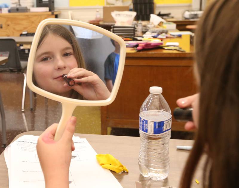 Ciara Schlenz uses lip stick to study forensics during the Area Career Center Hands-On Showcase on Thursday, June 8, 2023 at La Salle-Peru Township High School.
