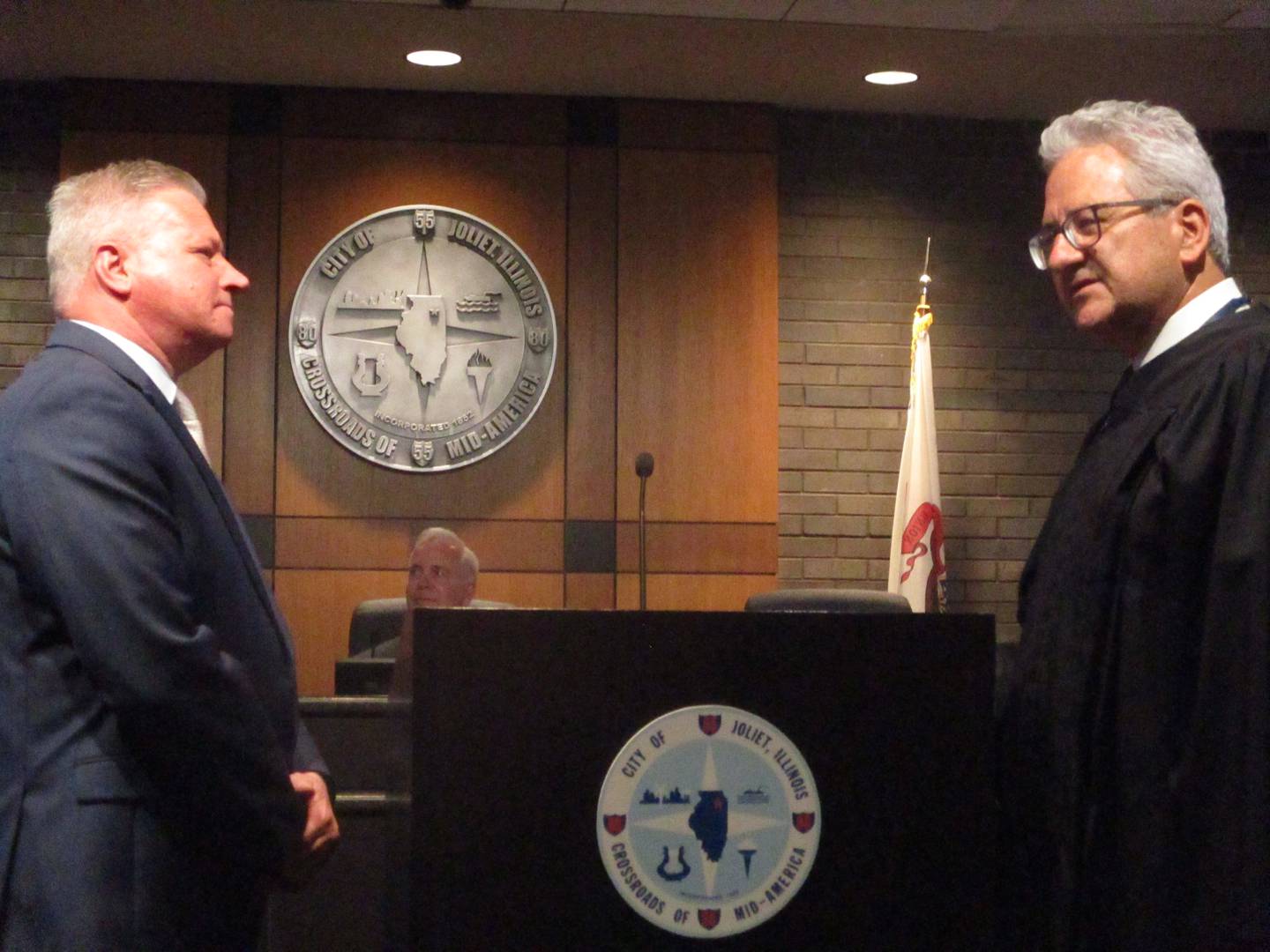 Joliet Councilman Joe Clement gets ready on Monday to take the oath of office for his second term, which was administered by Illinois 3rd District Appellate Court Judge Matt Bertaini (right). May 5, 2025