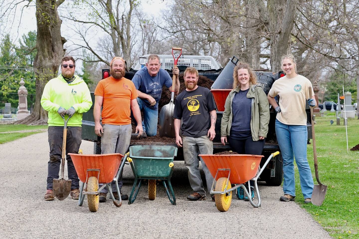 Volunteers gather for a group photo Saturday, April 19, 2025, during an event to plant 100 trees at Oakwood Cemetery in Princeton.